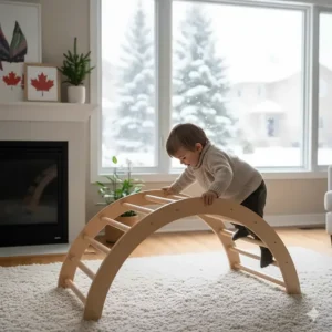 A wooden Pikler triangle or climbing arch in a living room, providing an indoor gross motor solution for Canadian winters.