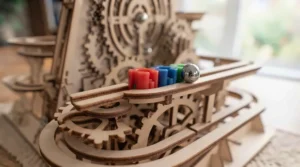 Steel marble rolling down the wooden track of the kit.