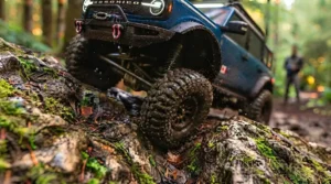 Remote control truck navigating a wooded forest trail.