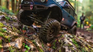 Off-road RC truck with LED lights on a dark trail.