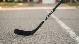 Lightweight composite street hockey stick with a reinforced blade for asphalt