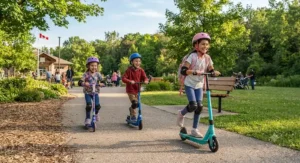 Young children enjoying an electric scooter ride along a paved path in a local Canadian park during summer.